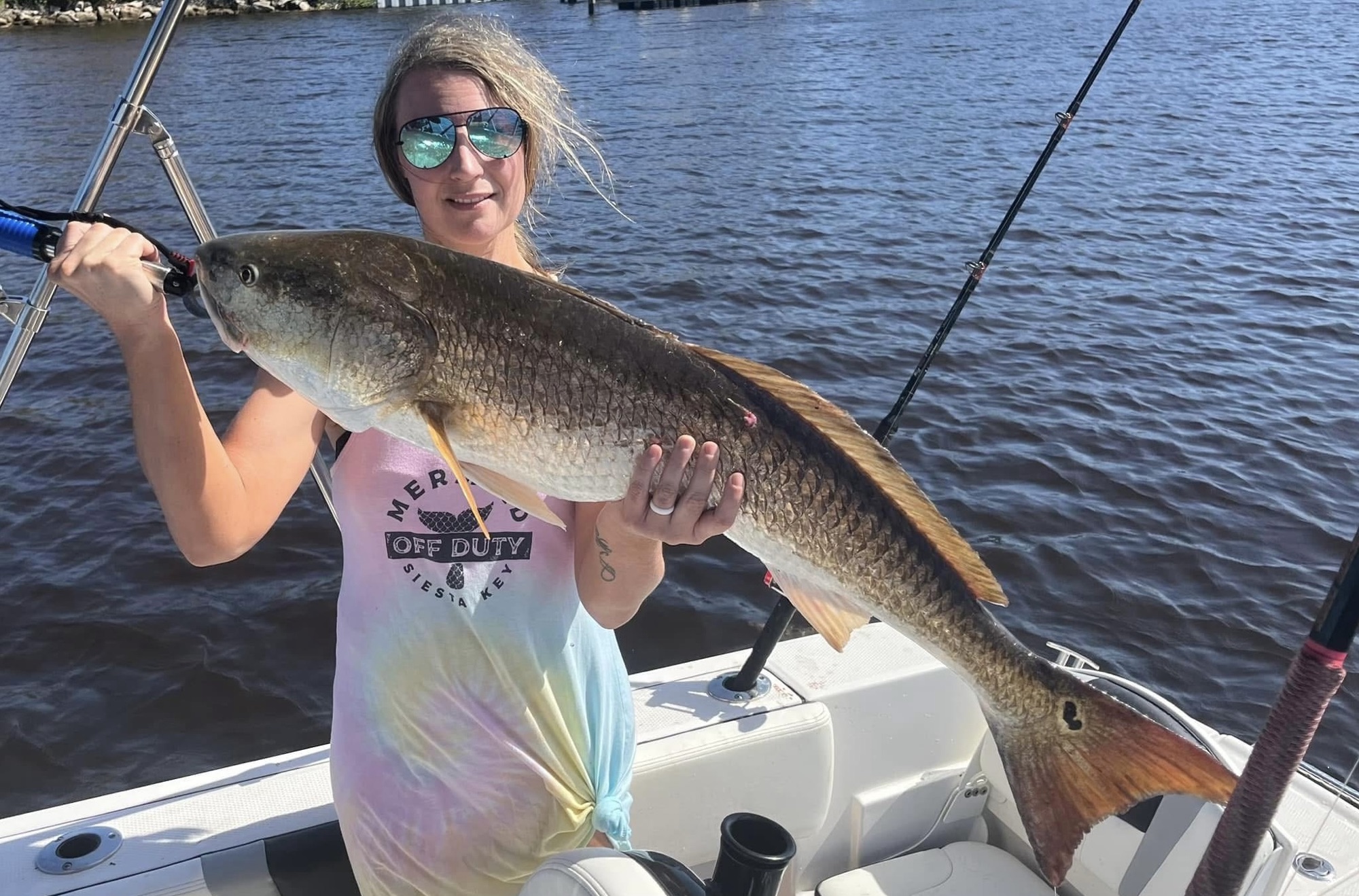 Angler showing a redfish catch on the boat