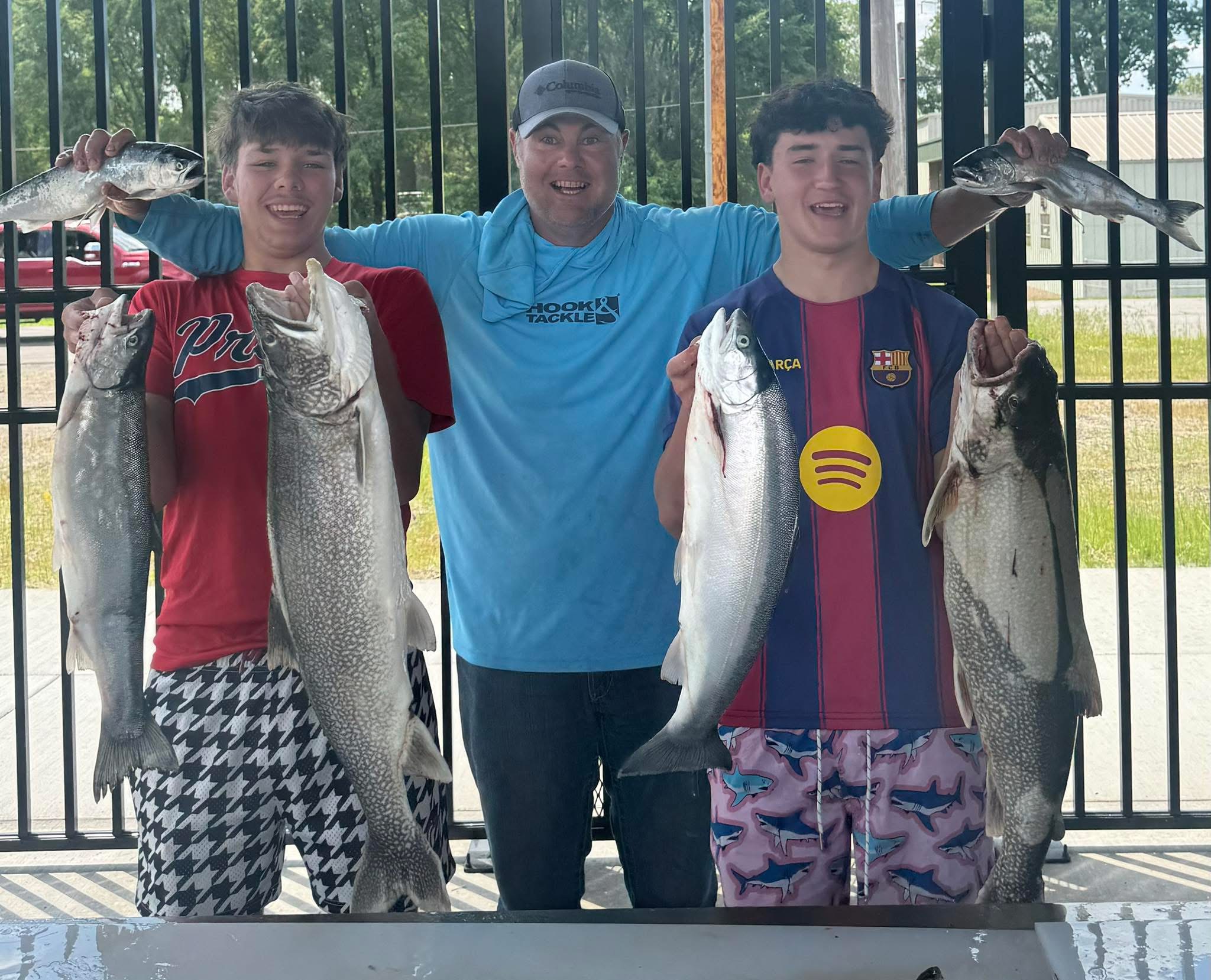Captain Heath with two anglers displaying their fish catches